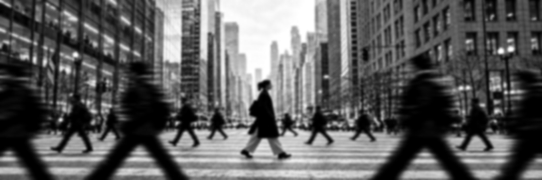A woman walking through a busy city crosswalk